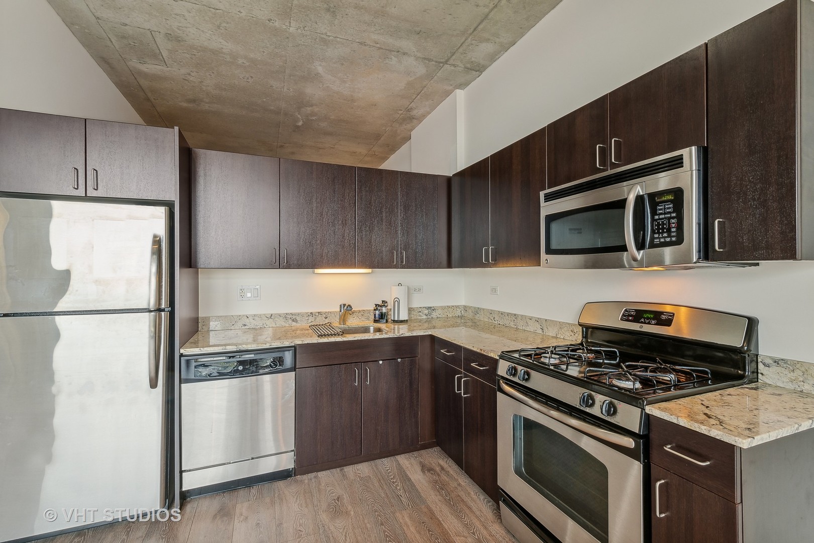 235 West Van Buren Street, Unit 1809 Chicago, IL 60607 - Photo 6 of 13 a kitchen with a sink stove and microwave