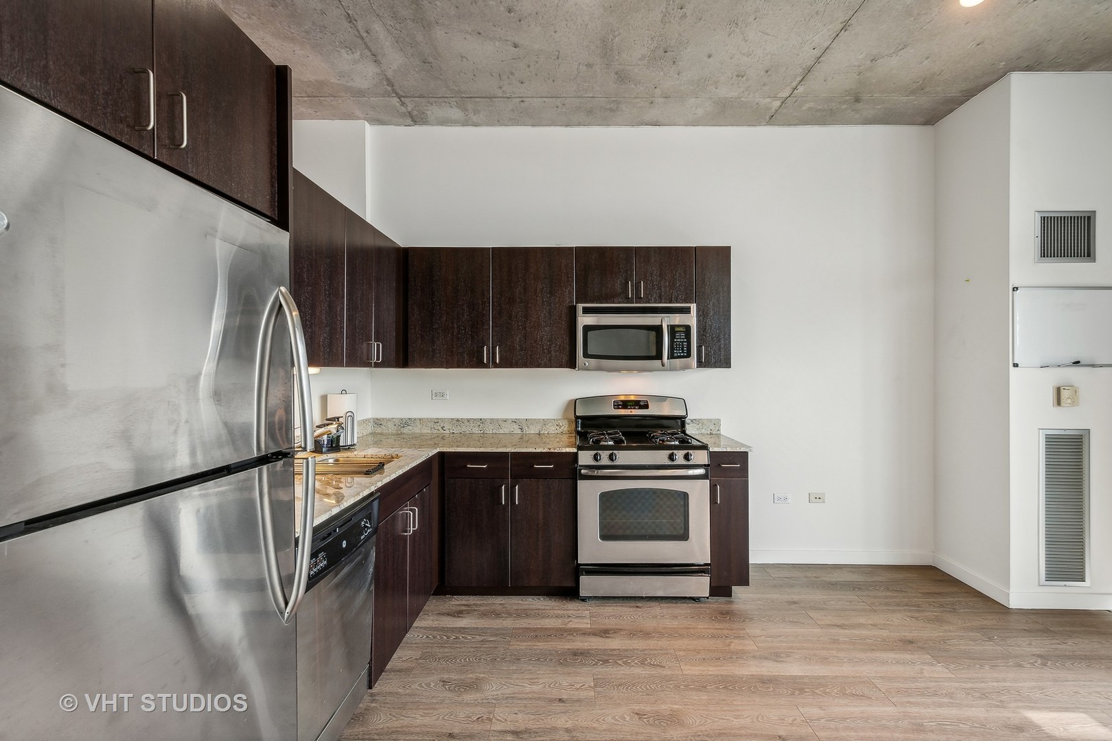 235 West Van Buren Street, Unit 1809 Chicago, IL 60607 - Photo 7 of 13 a kitchen with stainless steel appliances granite countertop a stove a sink and a refrigerator