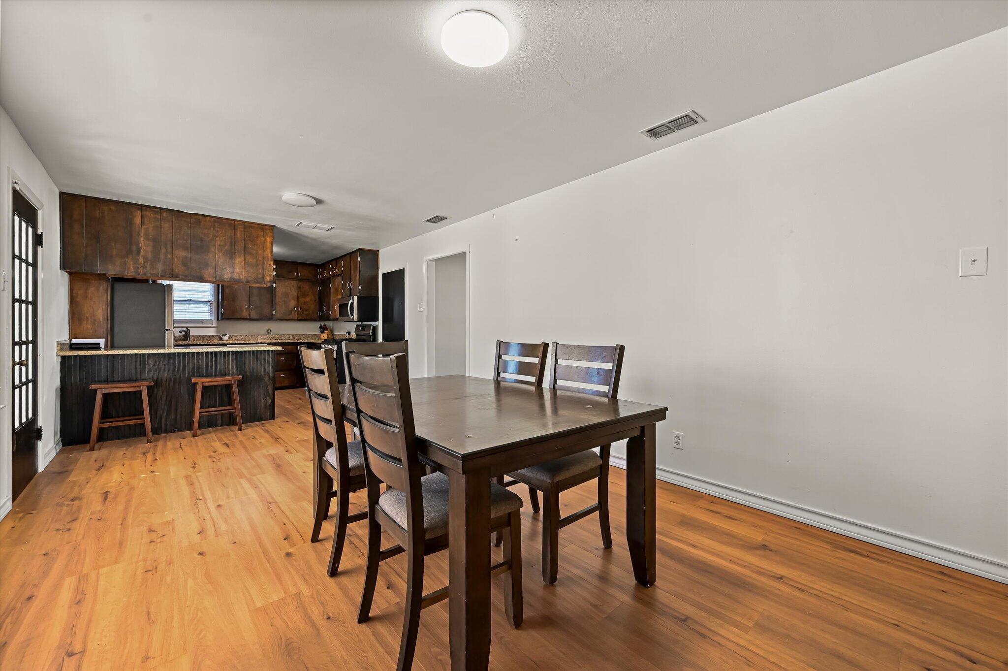 3707 25th Street Lubbock, TX 79410 - Photo 14 of 29 a view of a dining room with furniture and wooden floor