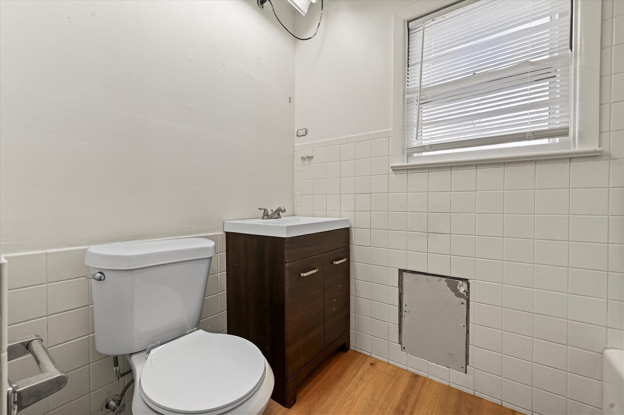 3707 25th Street Lubbock, TX 79410 - Photo 19 of 29 a bathroom with a toilet a sink and mirror