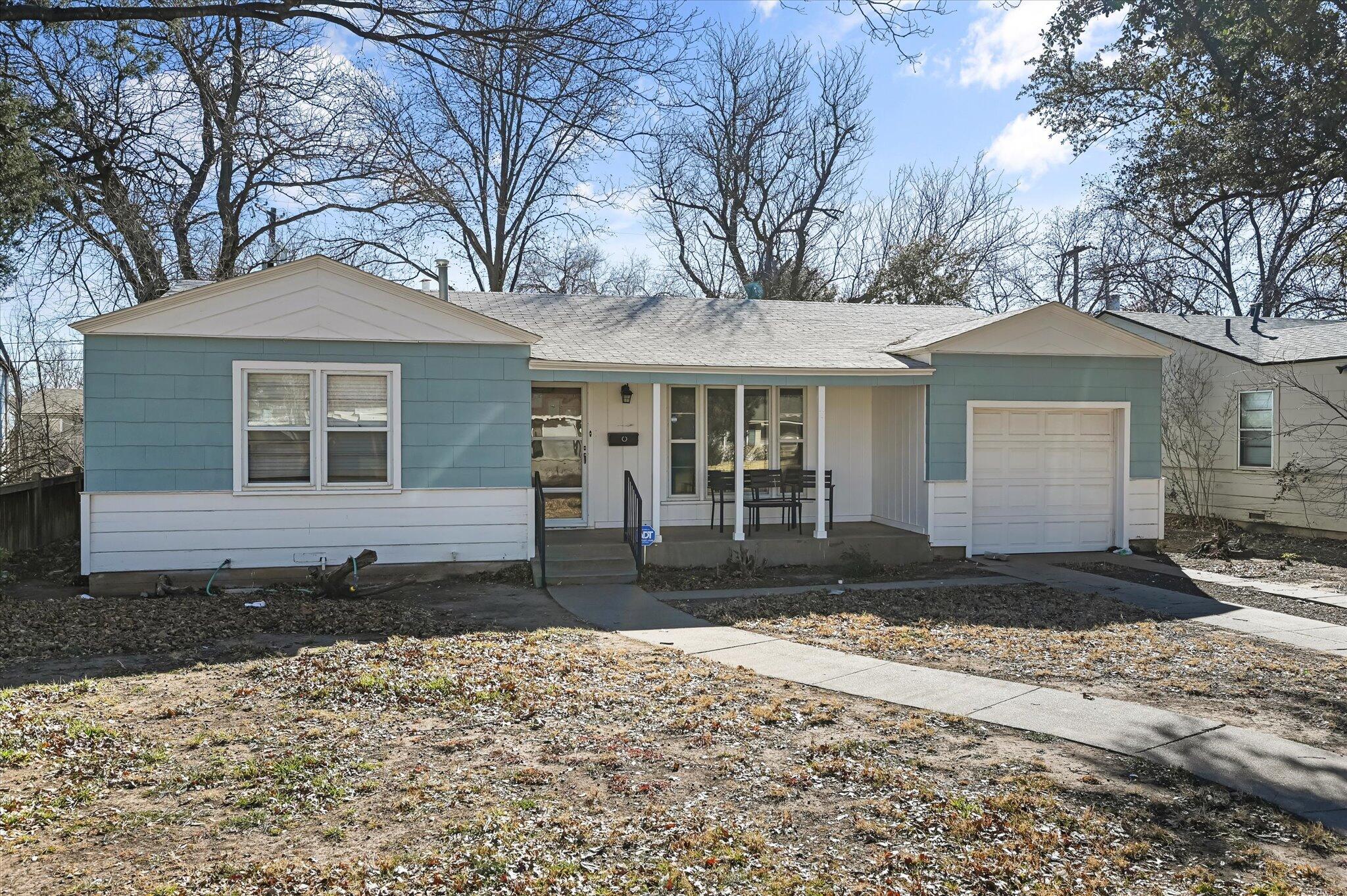 3707 25th Street Lubbock, TX 79410 - Photo 28 of 29 a front view of a house with a yard and garage
