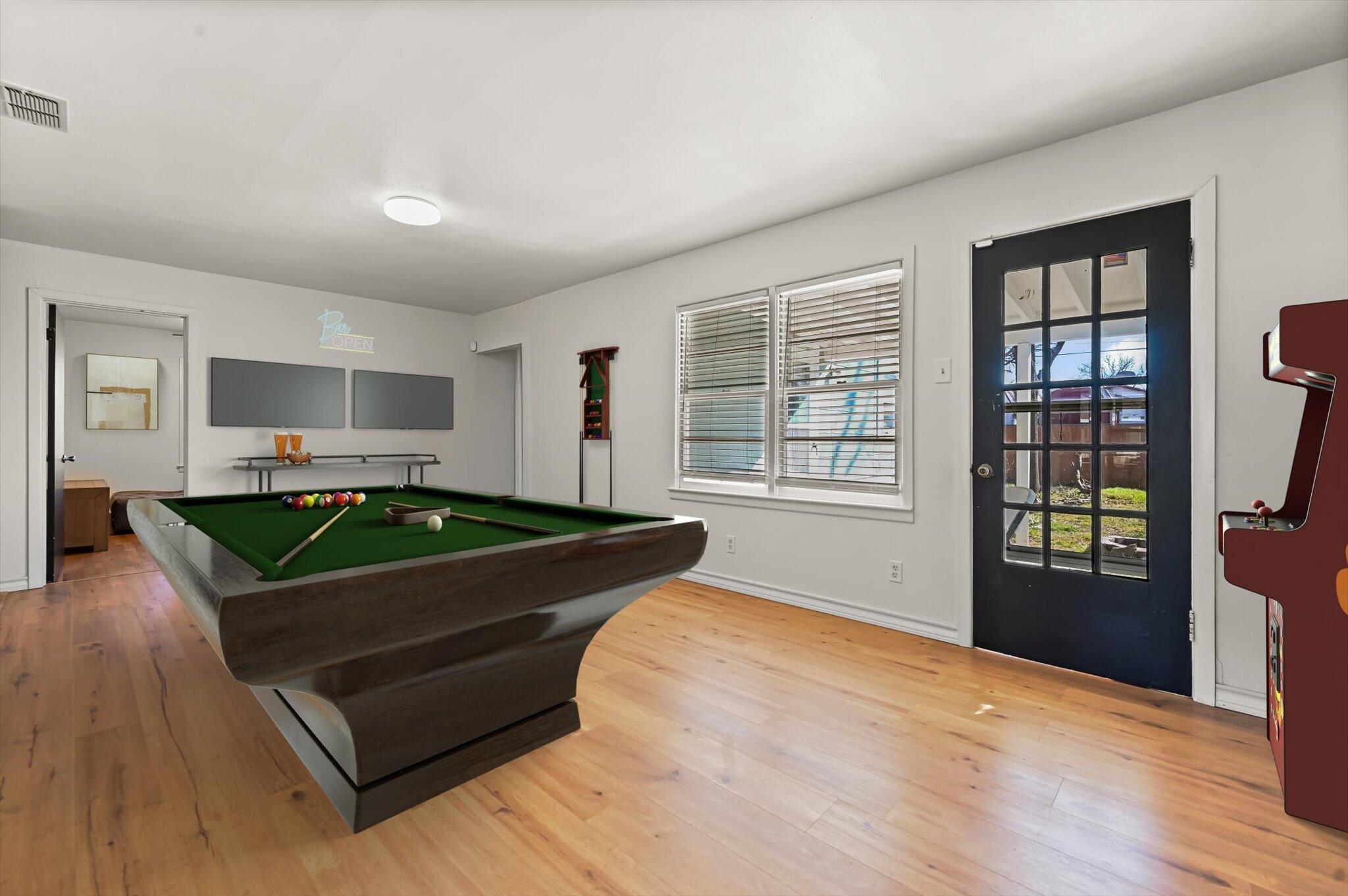 3707 25th Street Lubbock, TX 79410 - Photo 4 of 29 a living room with furniture flat screen tv and windows