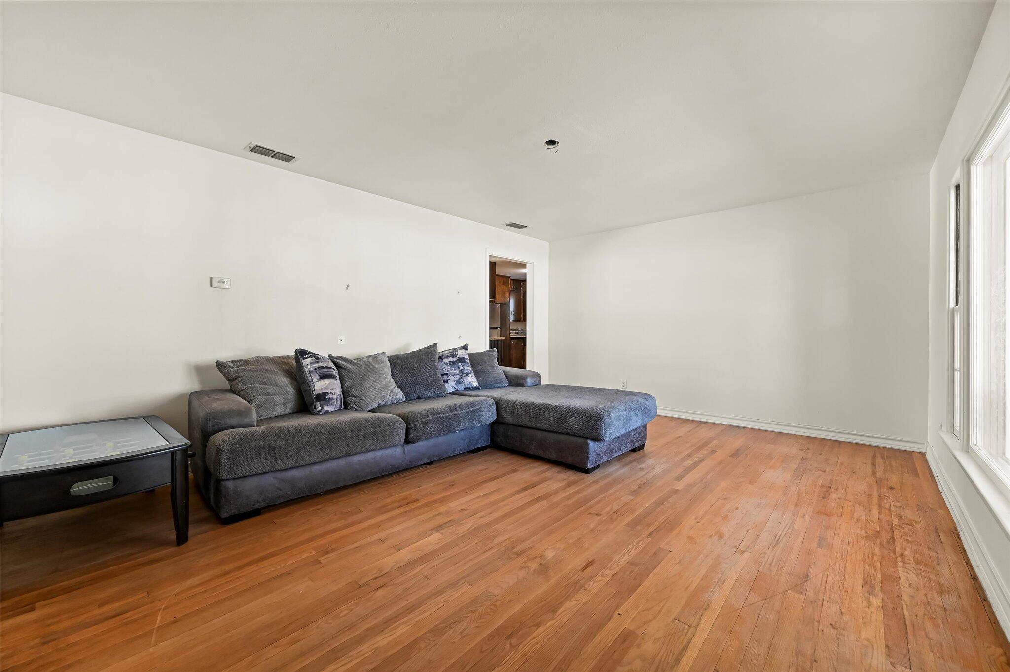 3707 25th Street Lubbock, TX 79410 - Photo 6 of 29 a living room with furniture and a wooden floor