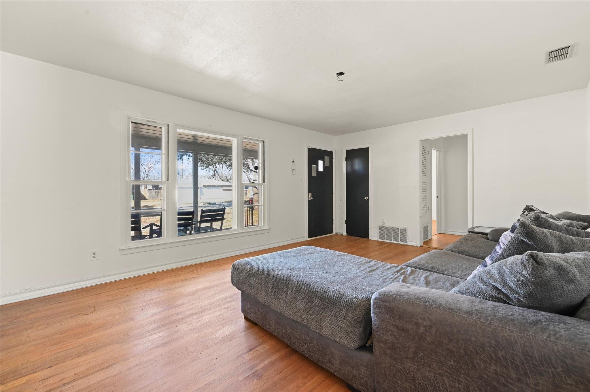 3707 25th Street Lubbock, TX 79410 - Photo 8 of 29 a bedroom with a large bed and a large window