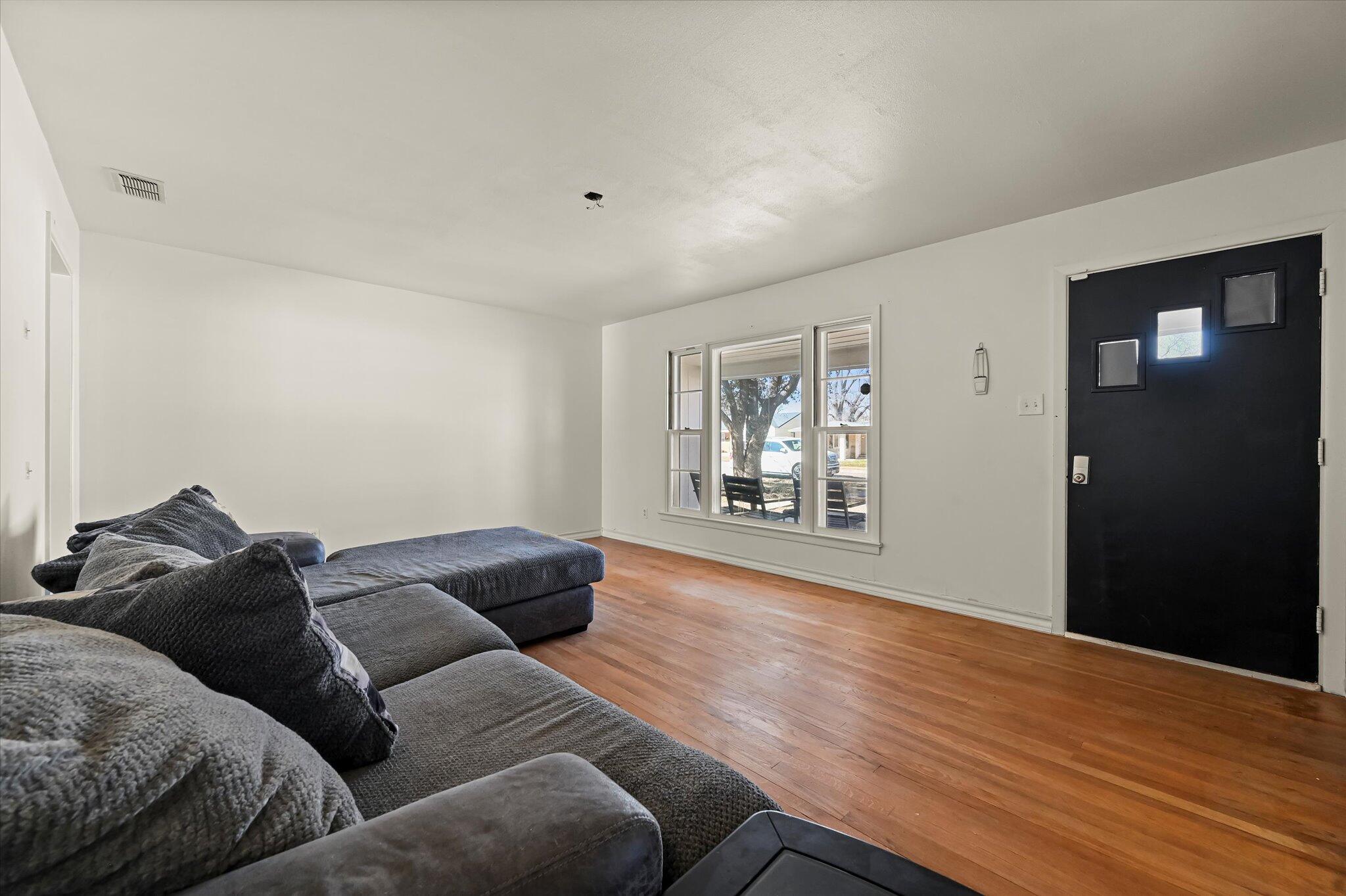 3707 25th Street Lubbock, TX 79410 - Photo 9 of 29 a living room with furniture and wooden floor