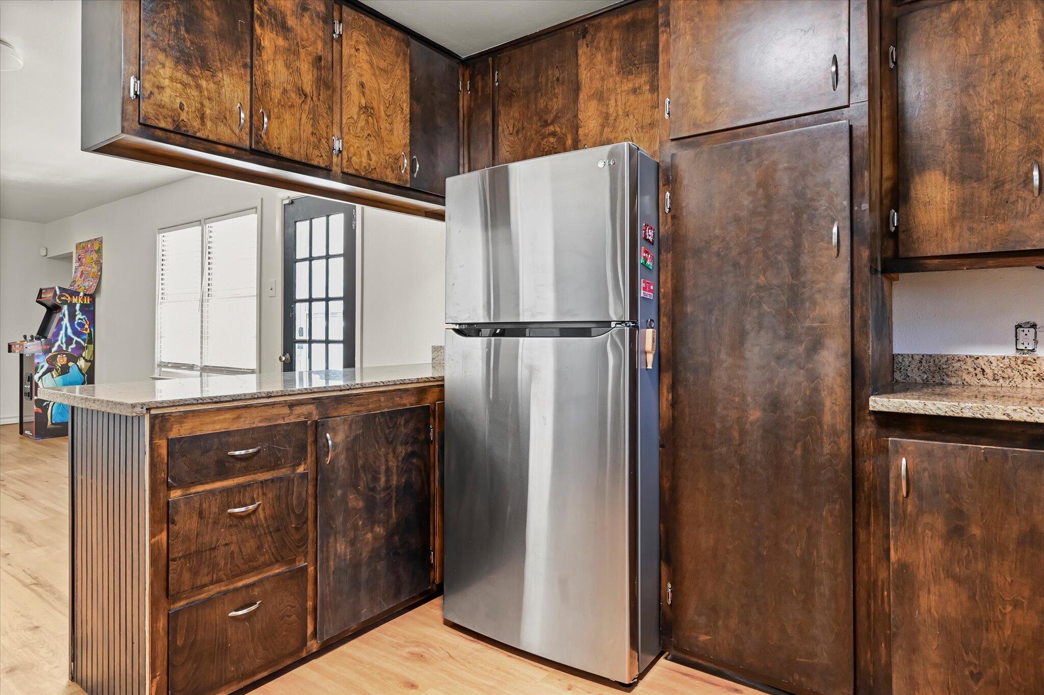 3707 25th Street Lubbock, TX 79410 - Photo 10 of 29 a white refrigerator freezer sitting inside of a kitchen