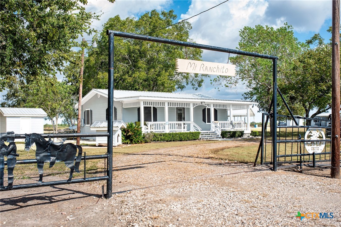 a view of a house with backyard and a tree