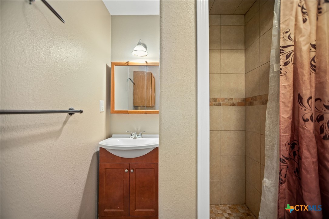 190 Hood Road Inez, TX 77968 - Photo 11 of 36 a bathroom with a sink and a mirror