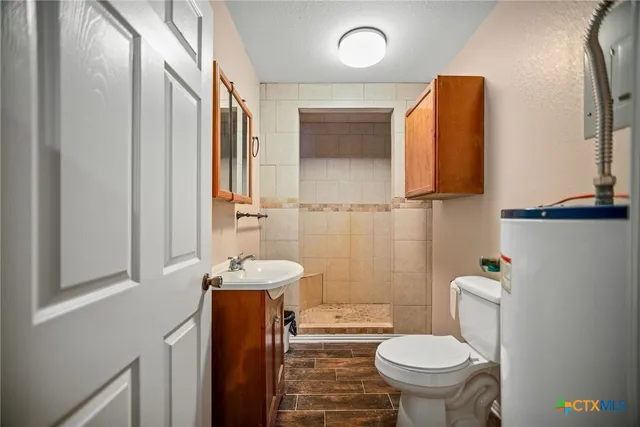 a bathroom with a sink toilet and mirror