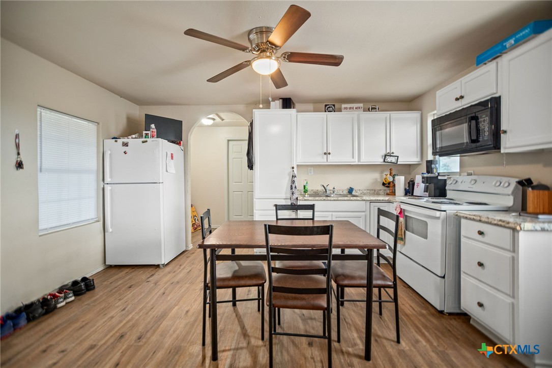 190 Hood Road Inez, TX 77968 - Photo 29 of 36 a kitchen with a refrigerator a white table and chairs