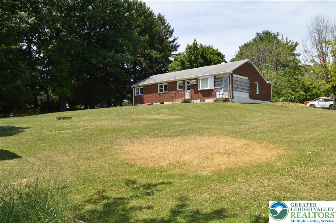 1819 Blue Barn Road Orefield, PA 18069 - Photo 6 of 21 Discover a charming brick residence nestled on an expansive green hillside.