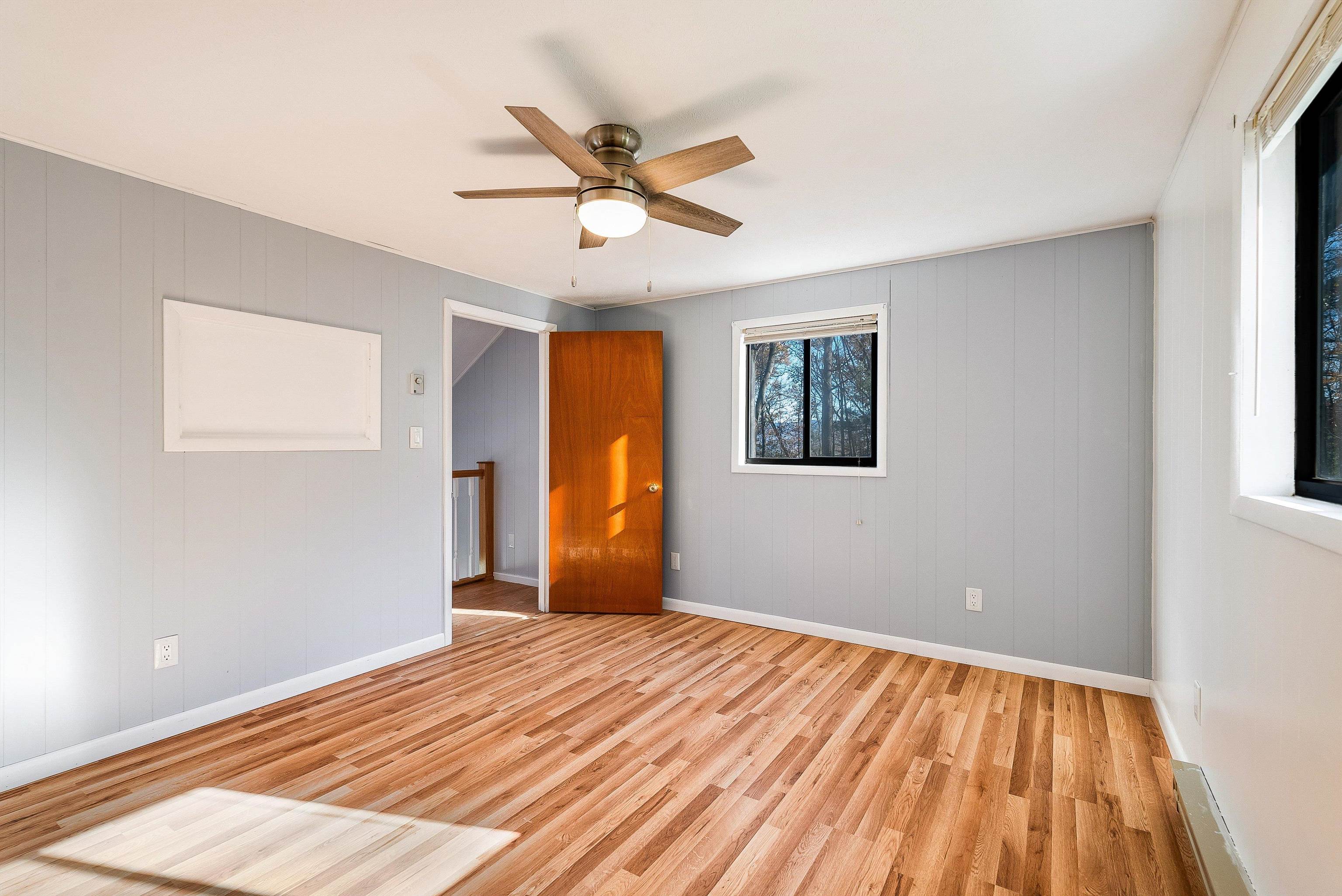 2497 Lacey Spring Road Broadway, VA 22815 - Photo 21 of 45 a view of a livingroom with wooden floor and a ceiling fan