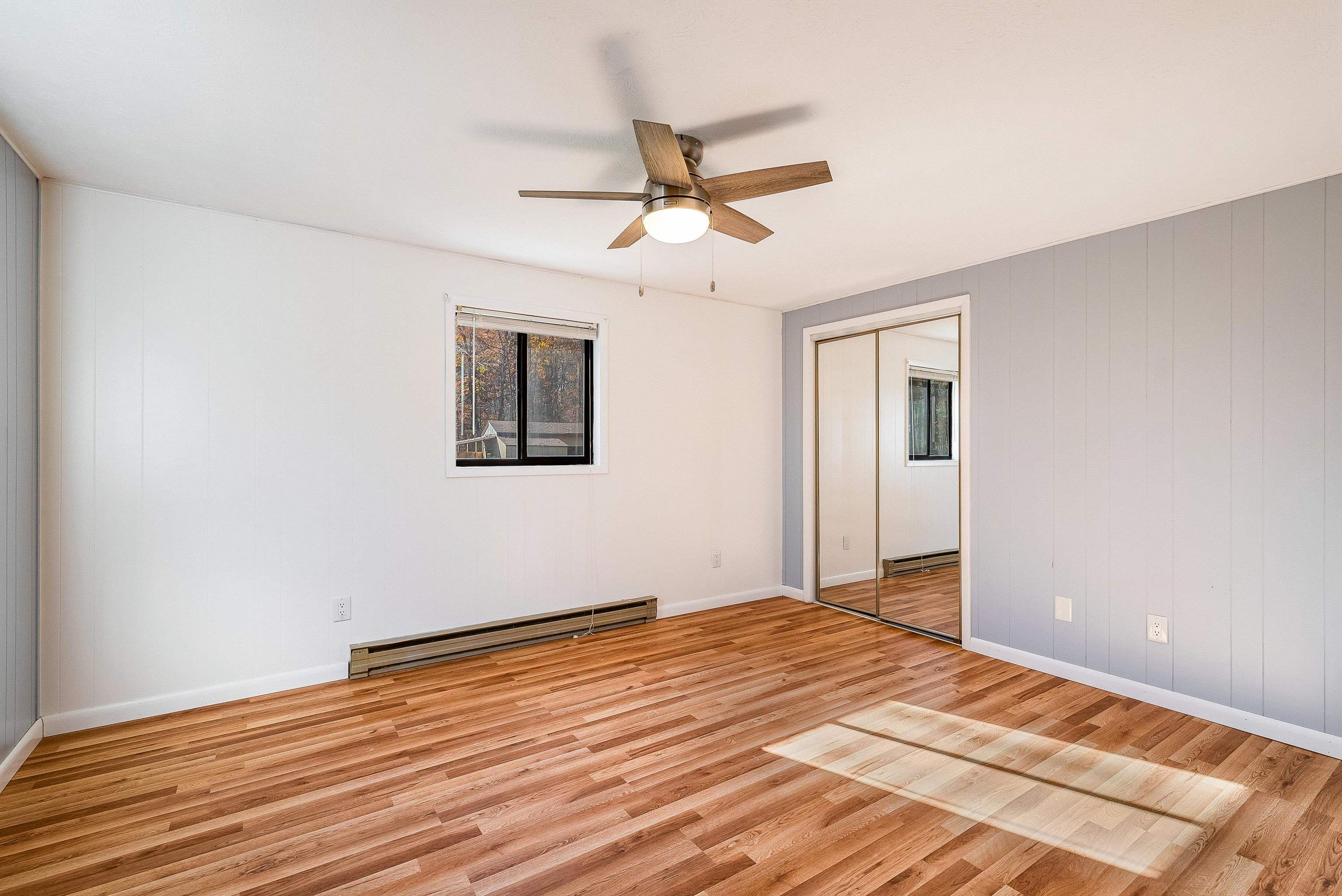 2497 Lacey Spring Road Broadway, VA 22815 - Photo 22 of 45 a view of a room with wooden floor and a ceiling fan