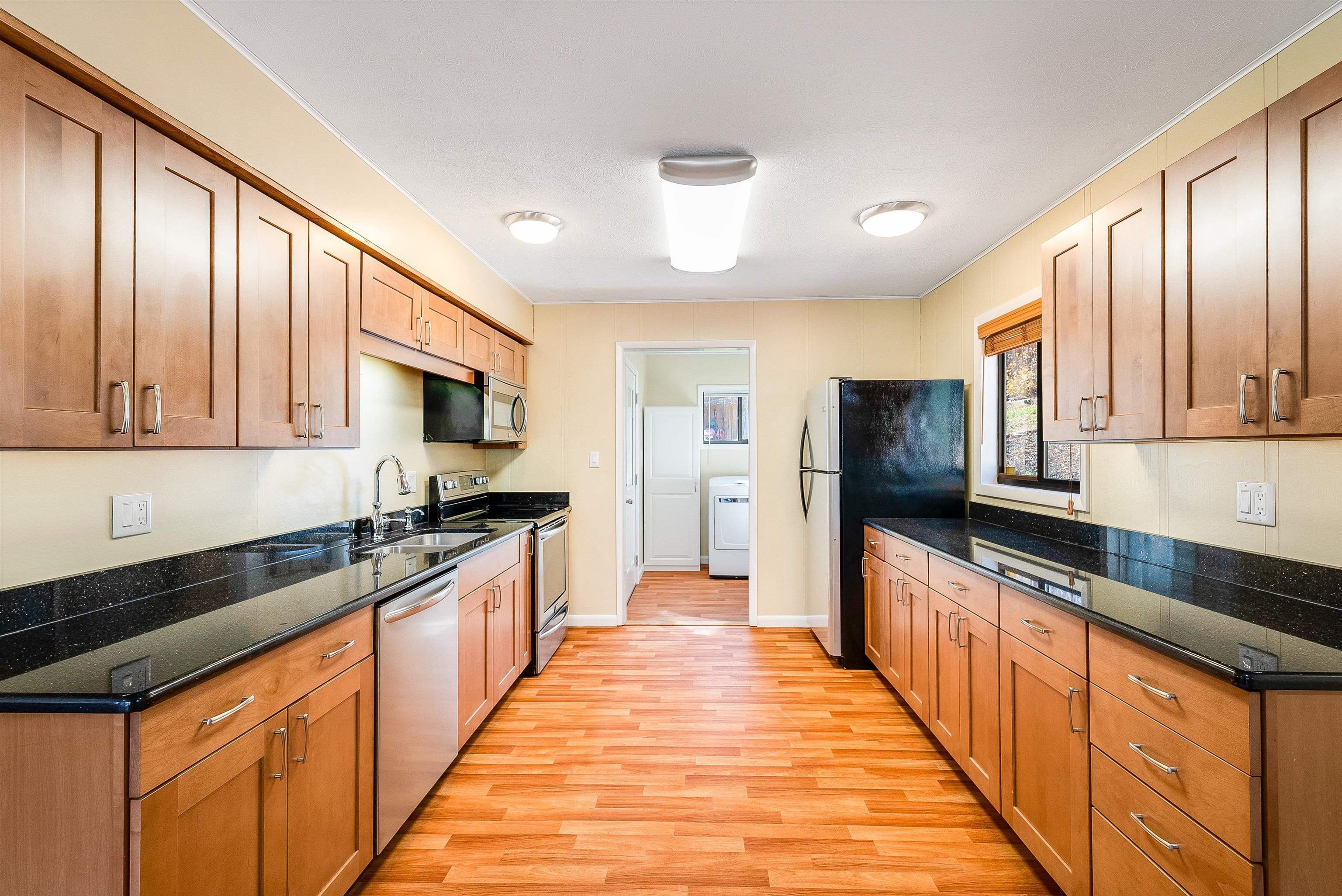 2497 Lacey Spring Road Broadway, VA 22815 - Photo 8 of 45 a large kitchen with stainless steel appliances wooden cabinets and a granite counter tops