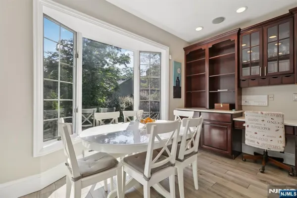 a dining room with furniture window and wooden floor