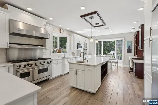 a kitchen with stove a sink and refrigerator