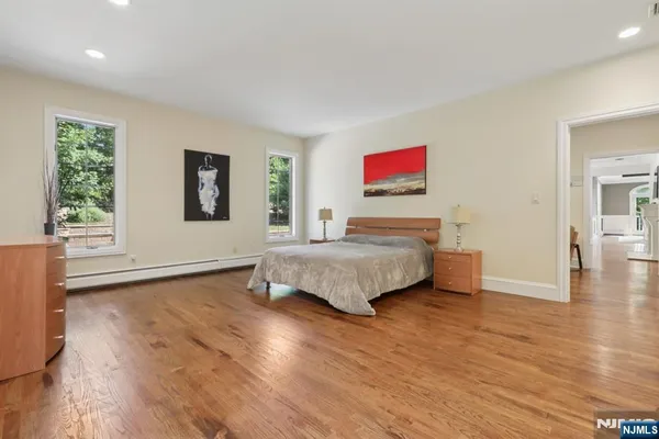 a bedroom with a bed and a large window