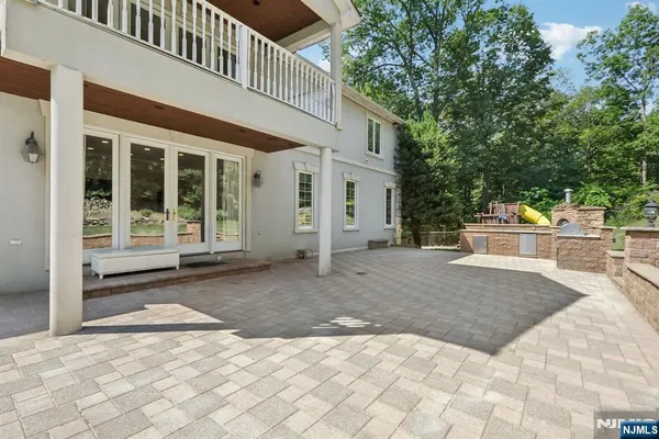 a view of a house with a yard and large tree
