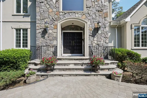 a front view of a house with potted plants