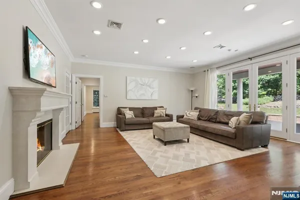 a living room with fireplace furniture and a wooden floor
