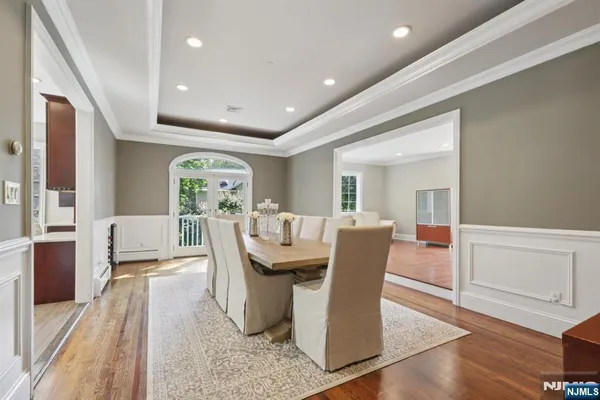 a dining room with furniture and wooden floor