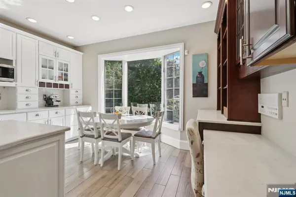a living room with furniture a large window and wooden floor