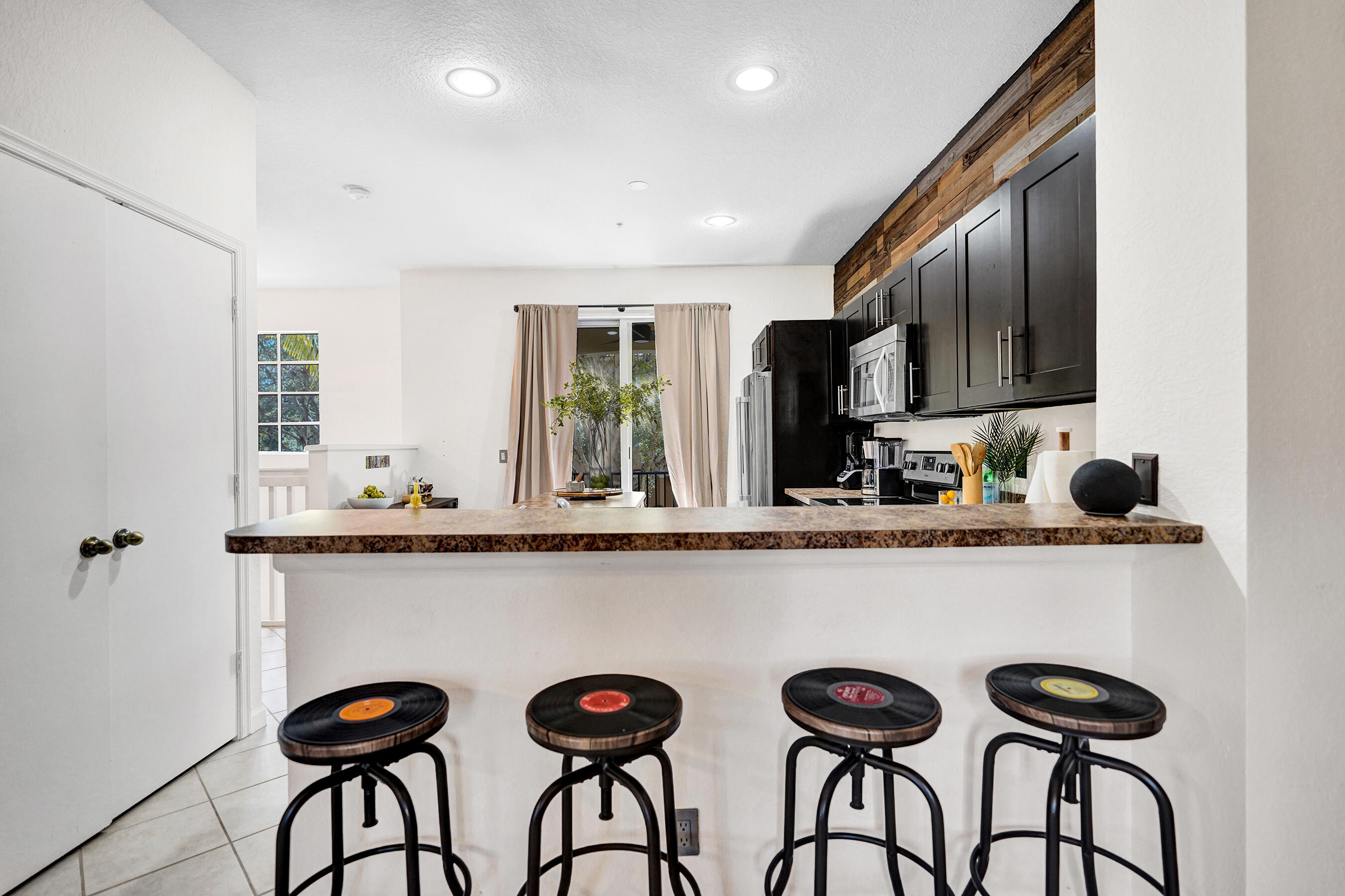 4533 Danson Way Delray Beach, FL 33445 - Photo 14 of 88 a kitchen with stainless steel appliances a refrigerator and a sink