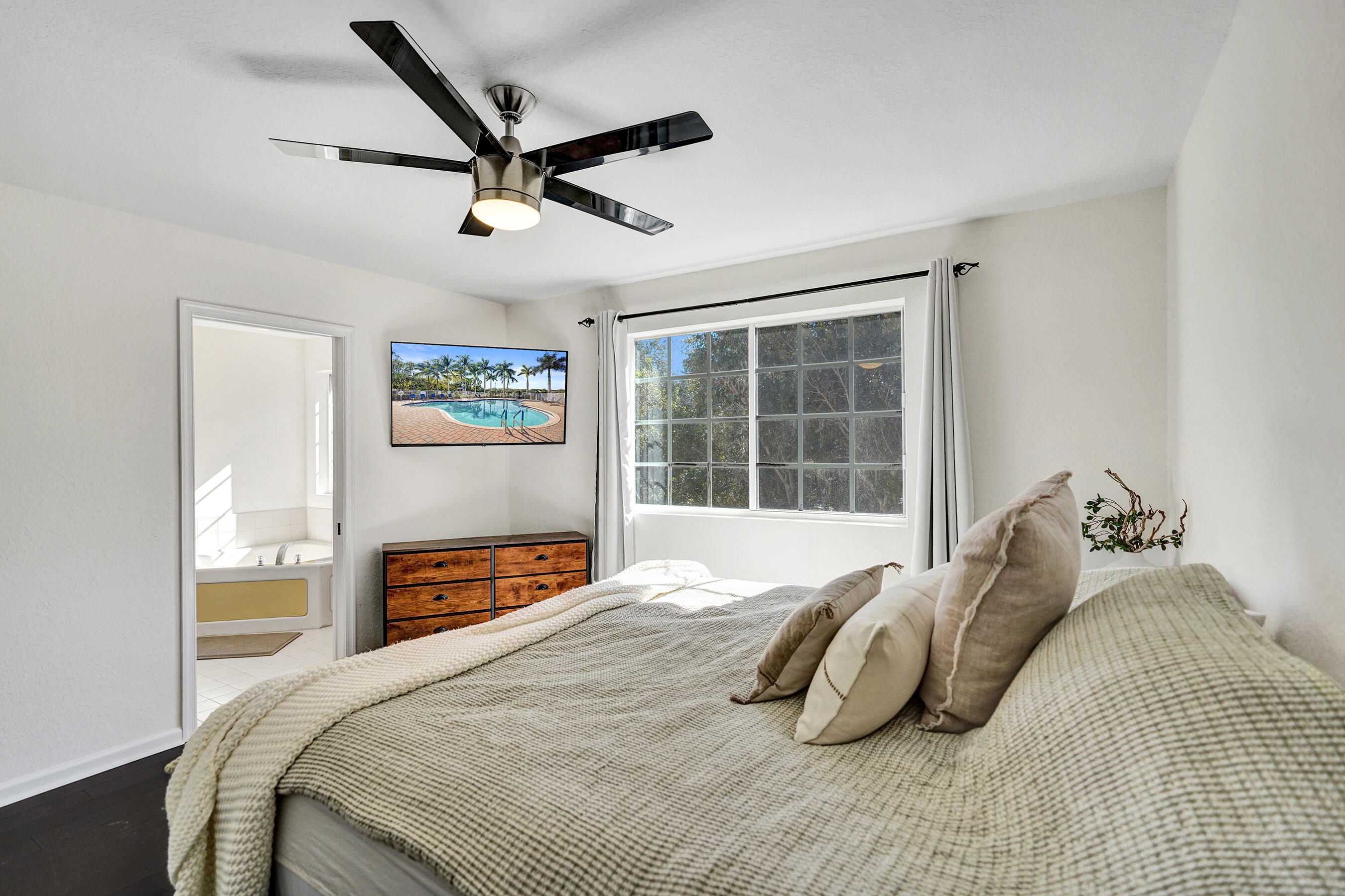 4533 Danson Way Delray Beach, FL 33445 - Photo 39 of 88 a bedroom with a bed and a large window