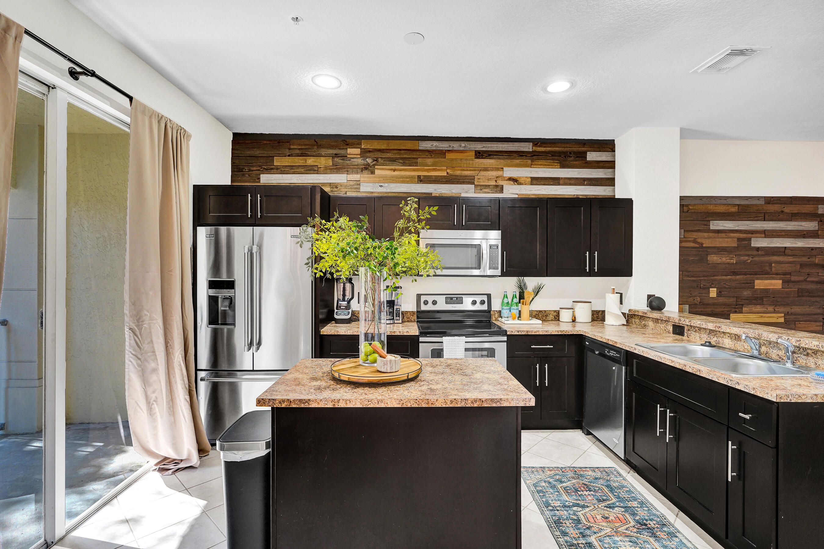 4533 Danson Way Delray Beach, FL 33445 - Photo 6 of 88 a kitchen with a sink refrigerator and cabinets