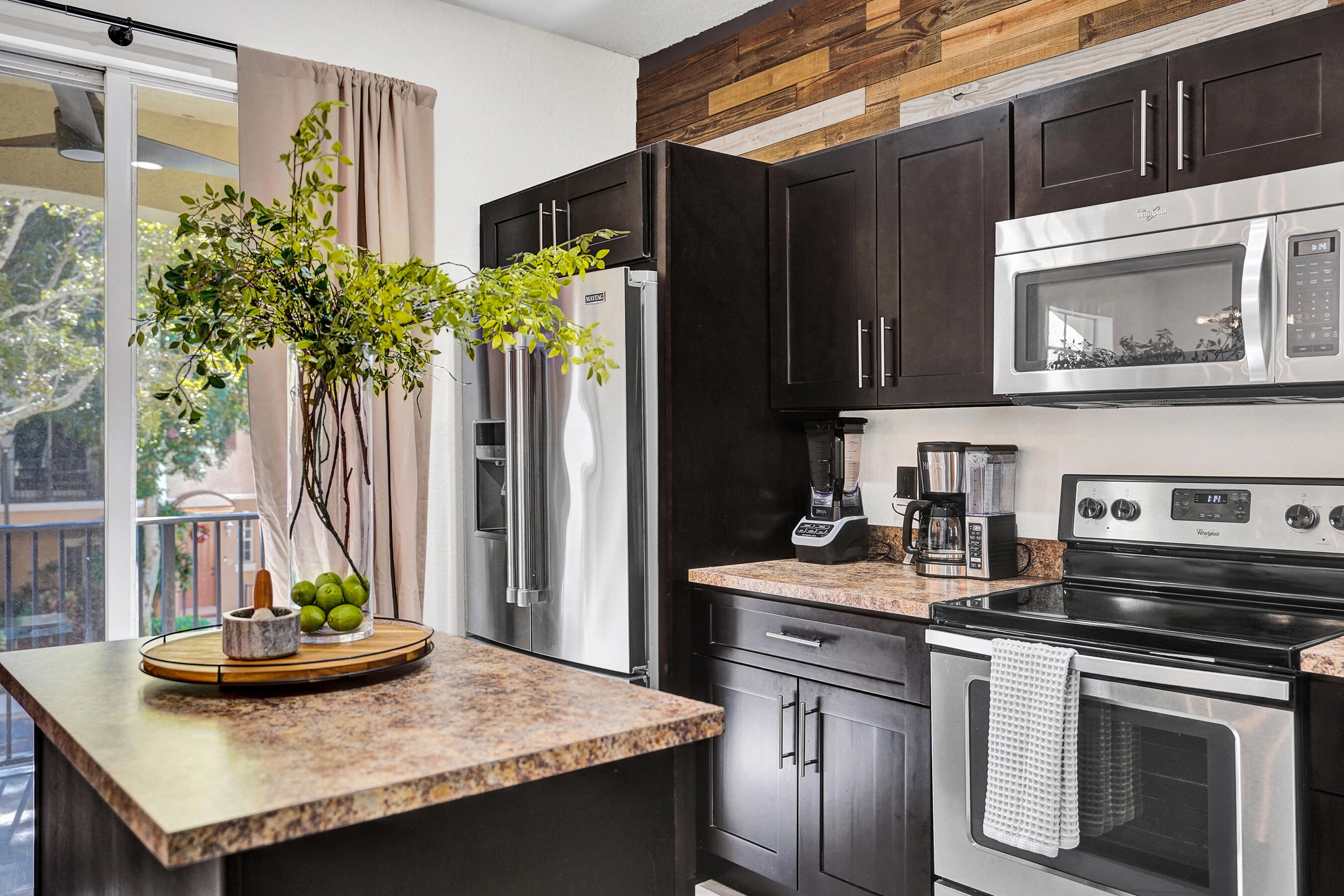 4533 Danson Way Delray Beach, FL 33445 - Photo 8 of 88 a kitchen with stainless steel appliances granite countertop a stove and a microwave