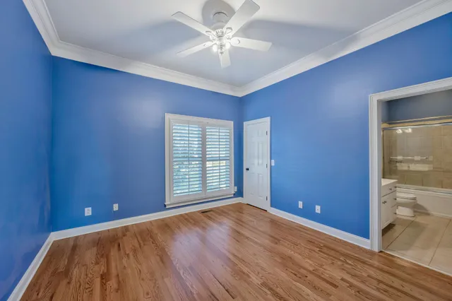 a view of a hallway with wooden floor and windows