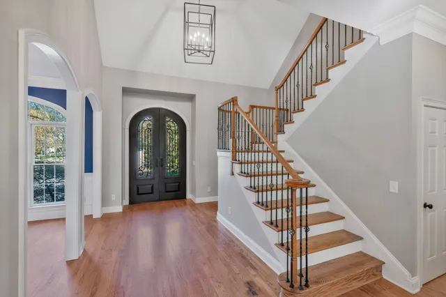 a view of a hallway with wooden floor and entryway