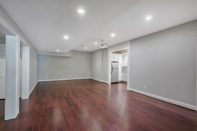 a view of a big house with a big yard and large trees