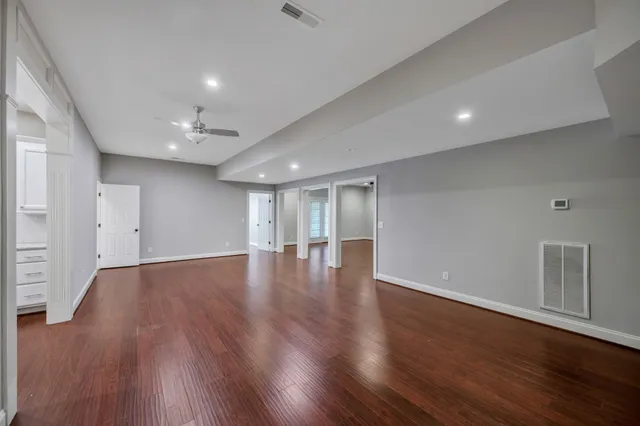 a front view of a house with yard and green space