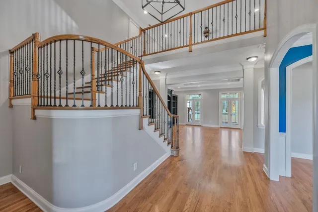 a large kitchen with stainless steel appliances a large counter top a stove and a refrigerator