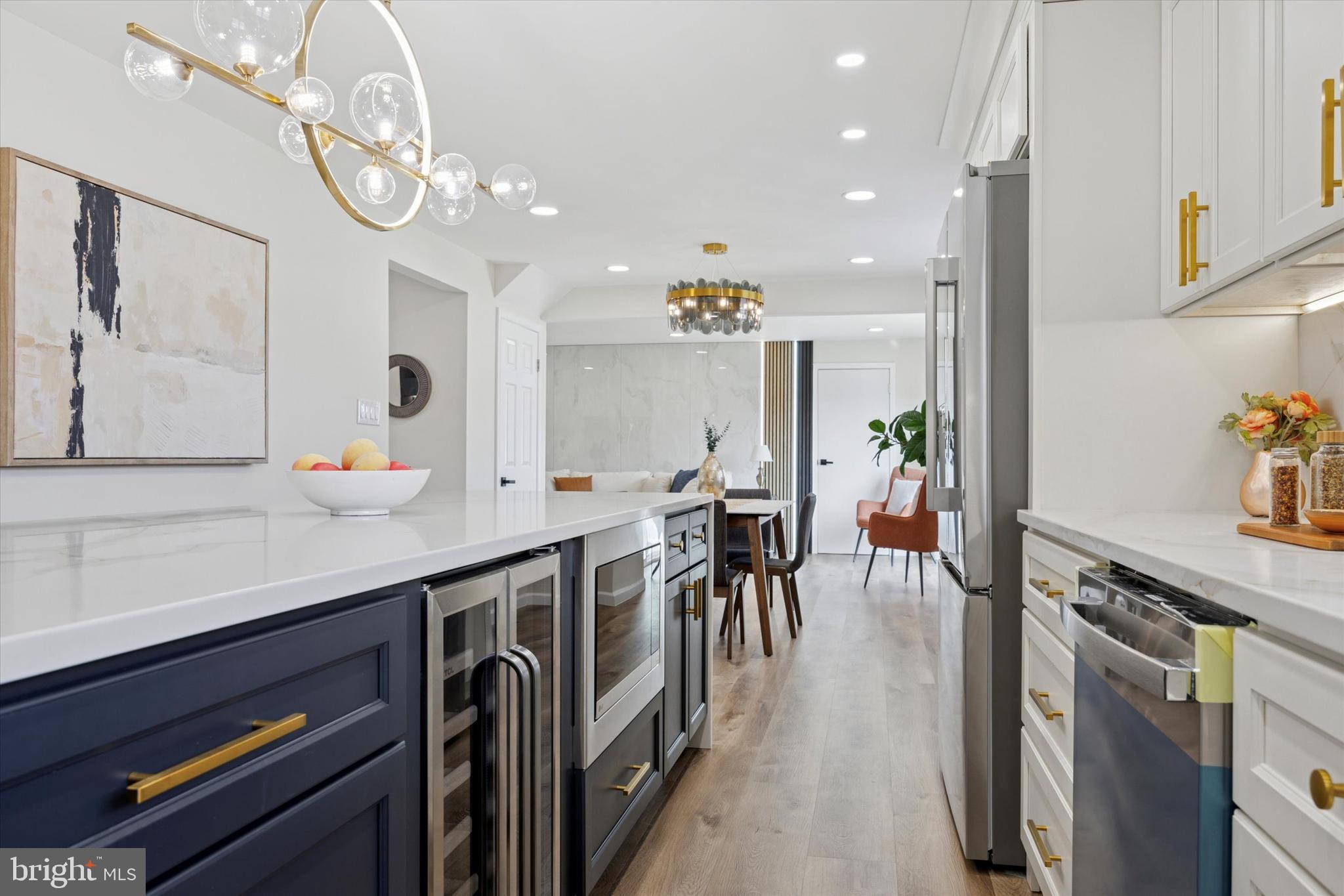 1574 Deer Run Road Warminster, PA 18974 - Photo 12 of 37 a kitchen with stainless steel appliances granite countertop a stove a sink dishwasher and a dining table with wooden floor