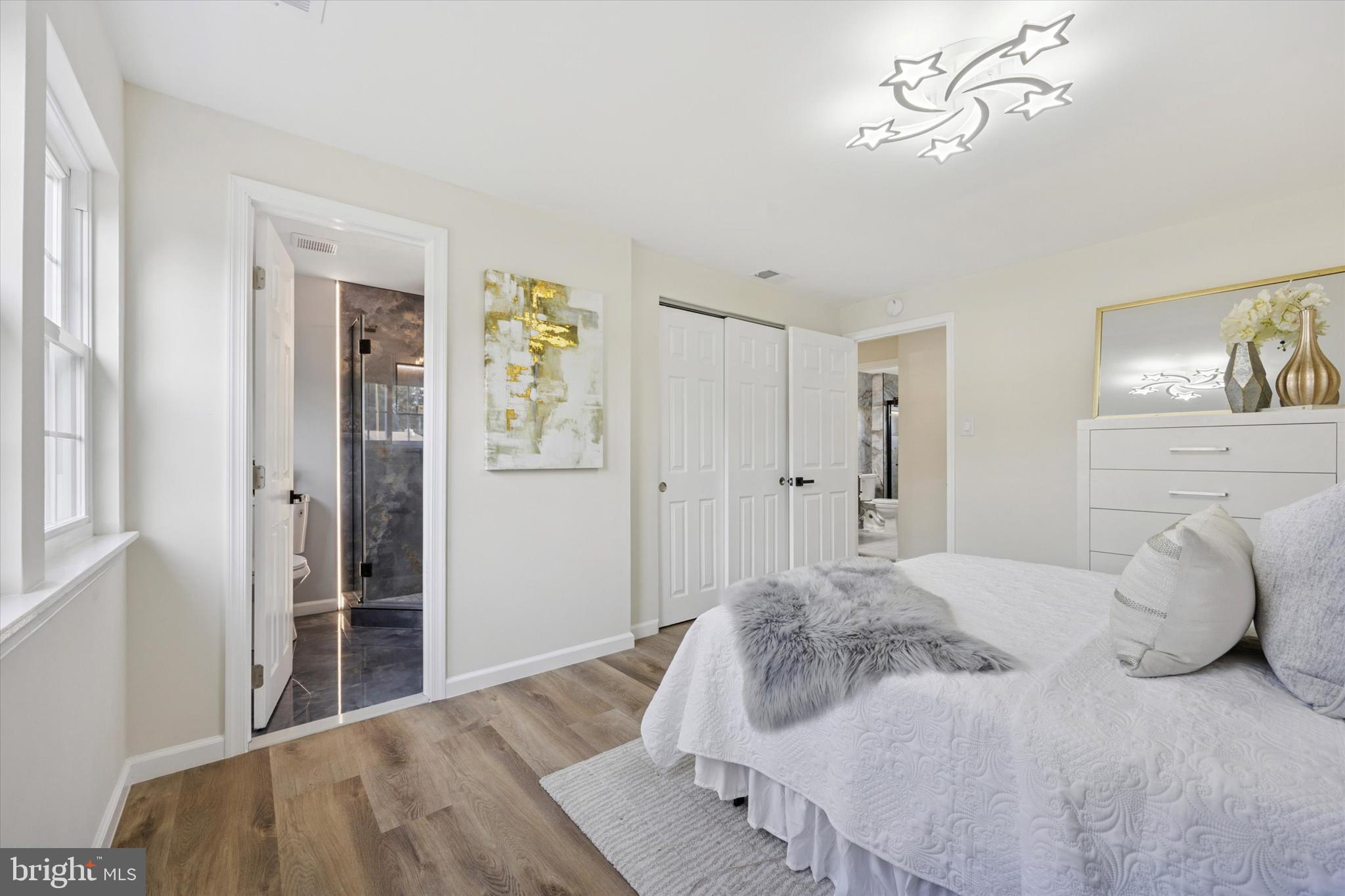 1574 Deer Run Road Warminster, PA 18974 - Photo 24 of 37 a bedroom with a large bed and a chandelier