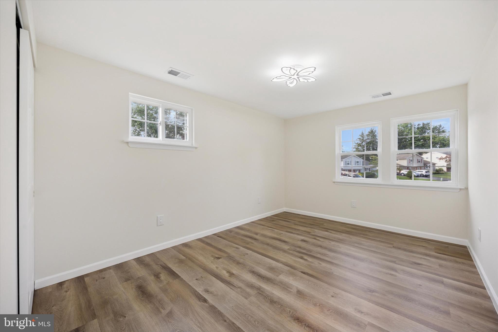 1574 Deer Run Road Warminster, PA 18974 - Photo 28 of 37 a view of an empty room with wooden floor and a window
