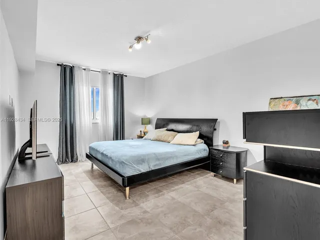 a bathroom with a granite countertop sink a toilet and a mirror