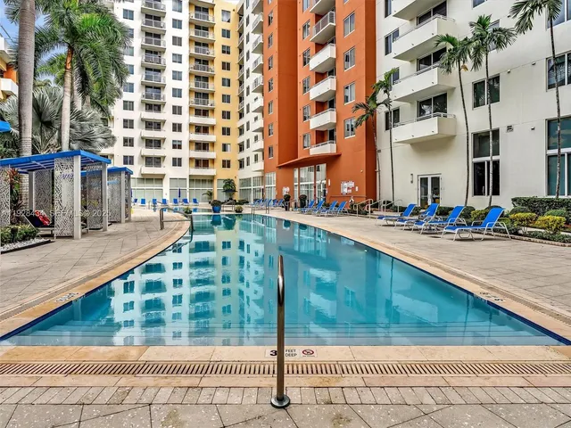 a view of a workspace with a computer on a desk and chair