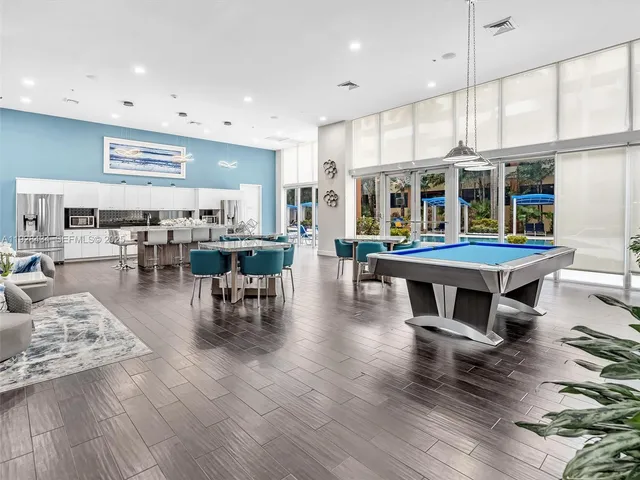 a living room with kitchen island furniture and a large window
