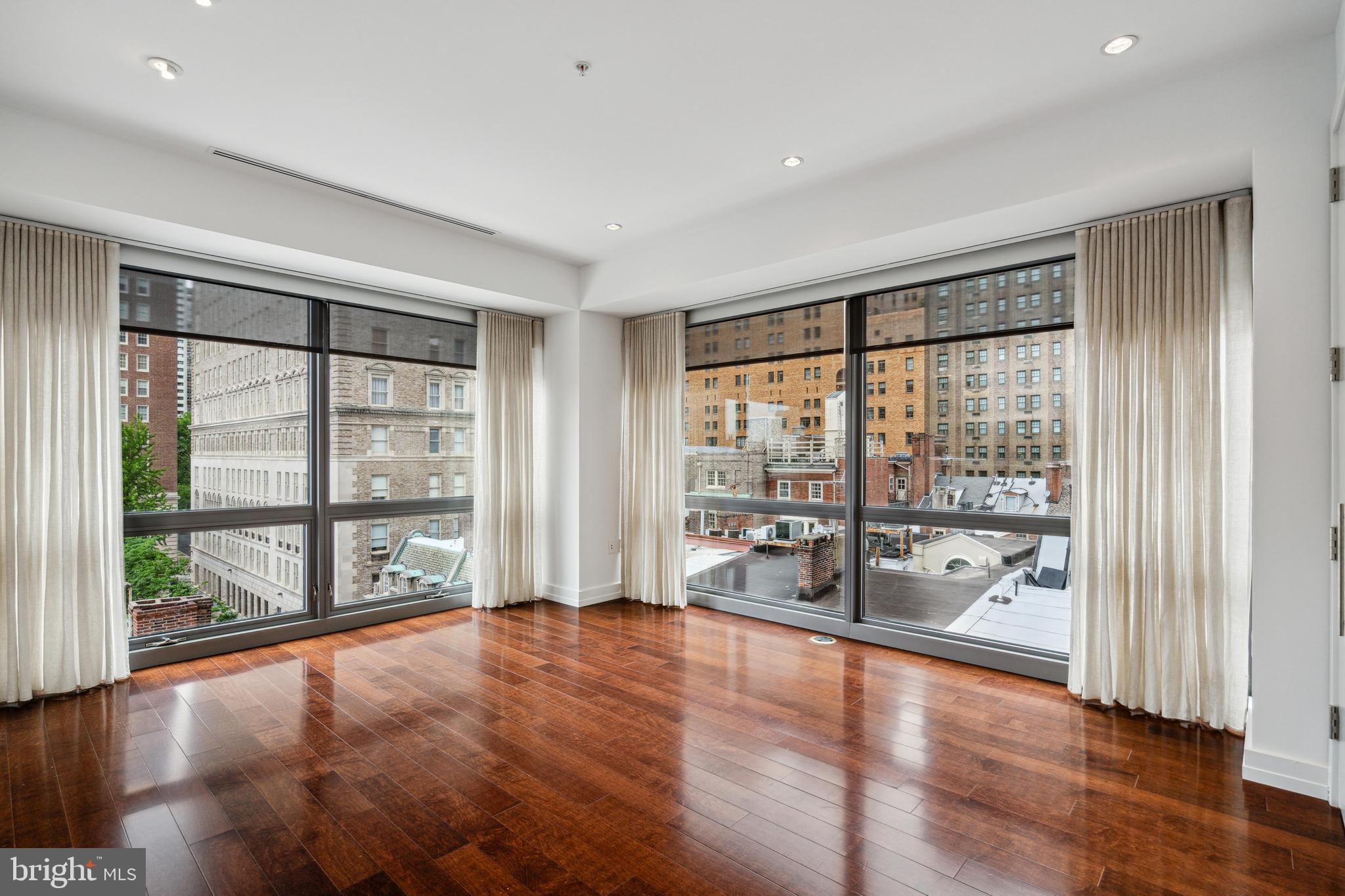1706 Rittenhouse Square, Unit 402 Philadelphia, PA 19103 - Photo 12 of 27 a view of an empty room with wooden floor and a window