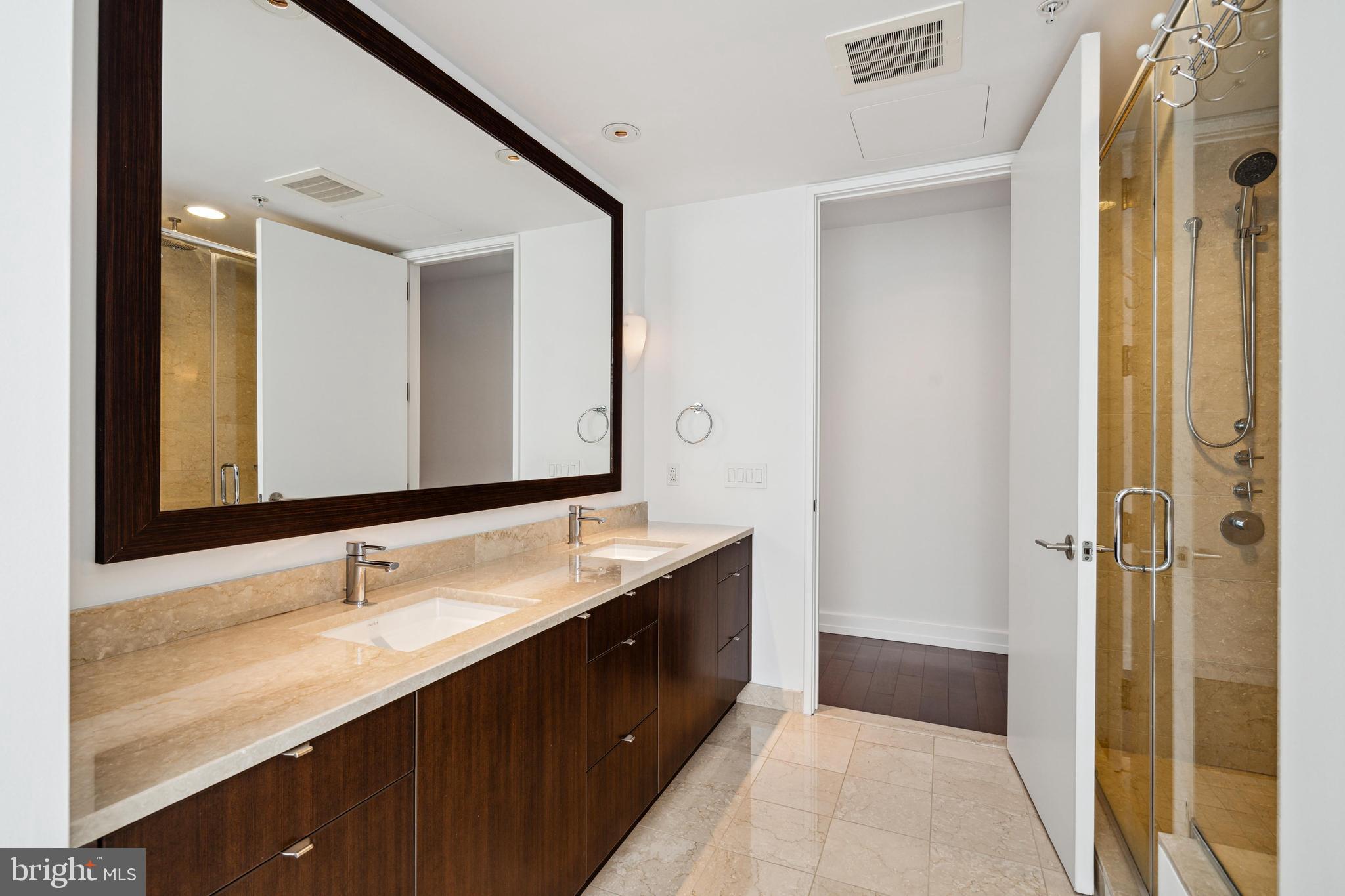 1706 Rittenhouse Square, Unit 402 Philadelphia, PA 19103 - Photo 15 of 27 a bathroom with a sink and a mirror