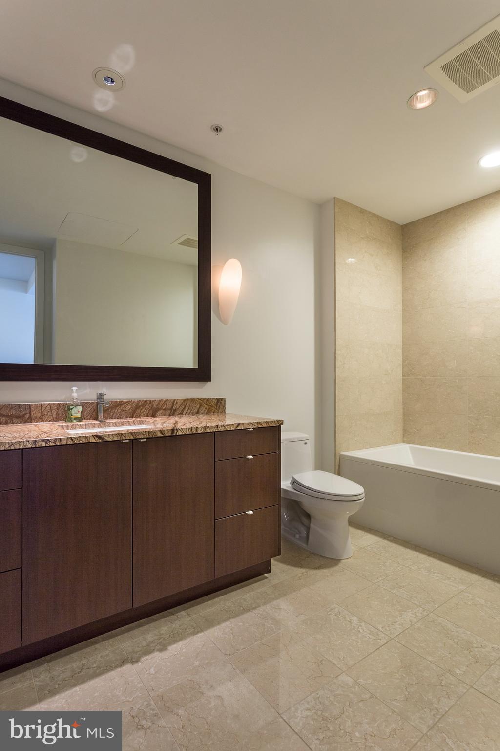 1706 Rittenhouse Square, Unit 402 Philadelphia, PA 19103 - Photo 18 of 27 a bathroom with a granite countertop sink and a toilet