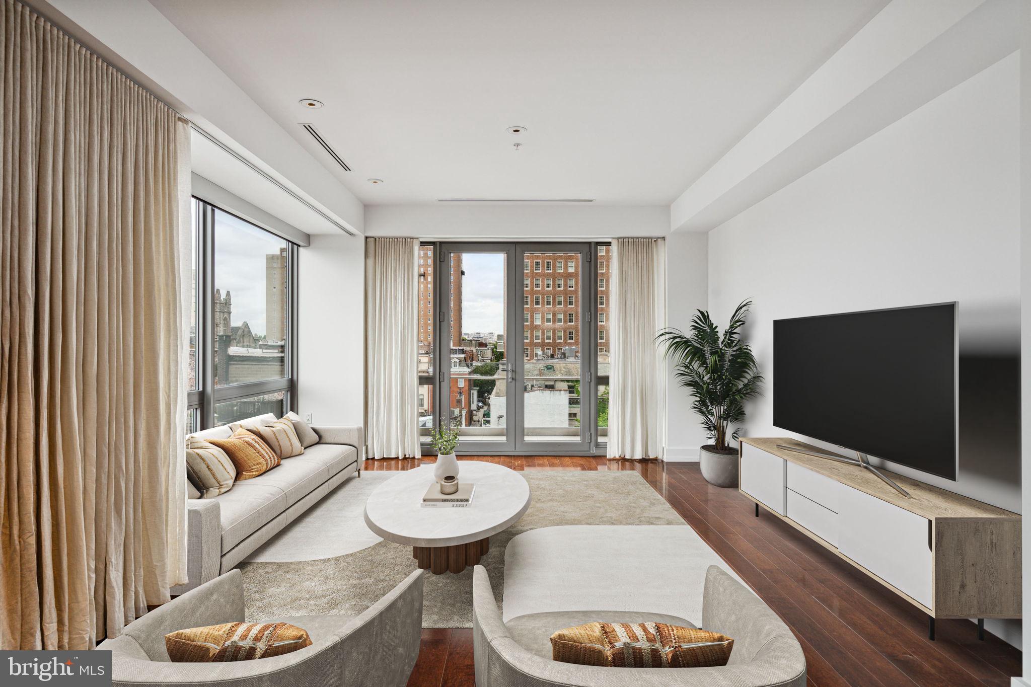 1706 Rittenhouse Square, Unit 402 Philadelphia, PA 19103 - Photo 2 of 27 a living room with furniture and a flat screen tv