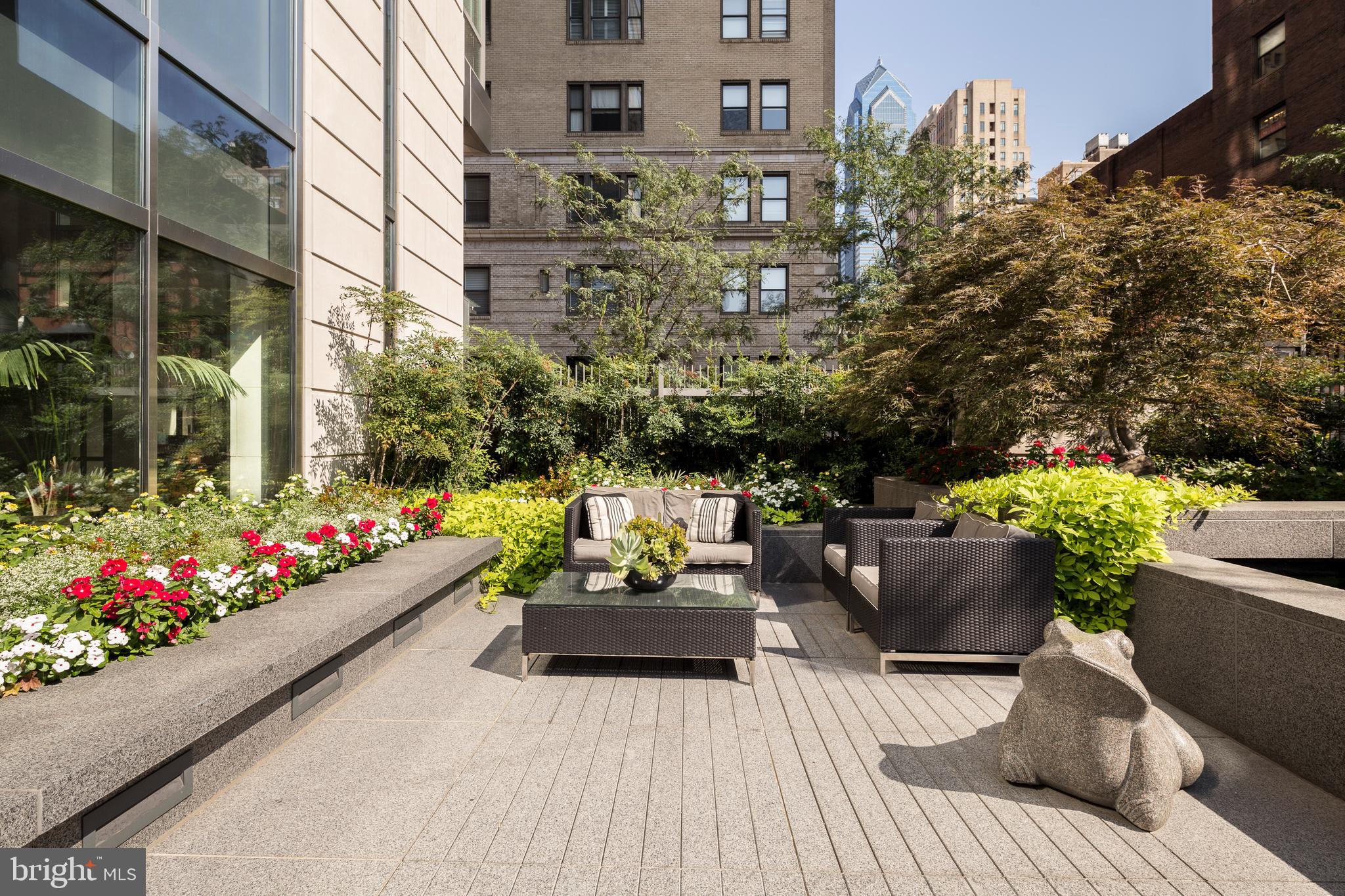 1706 Rittenhouse Square, Unit 402 Philadelphia, PA 19103 - Photo 24 of 27 a view of a patio filled with furniture and flowers