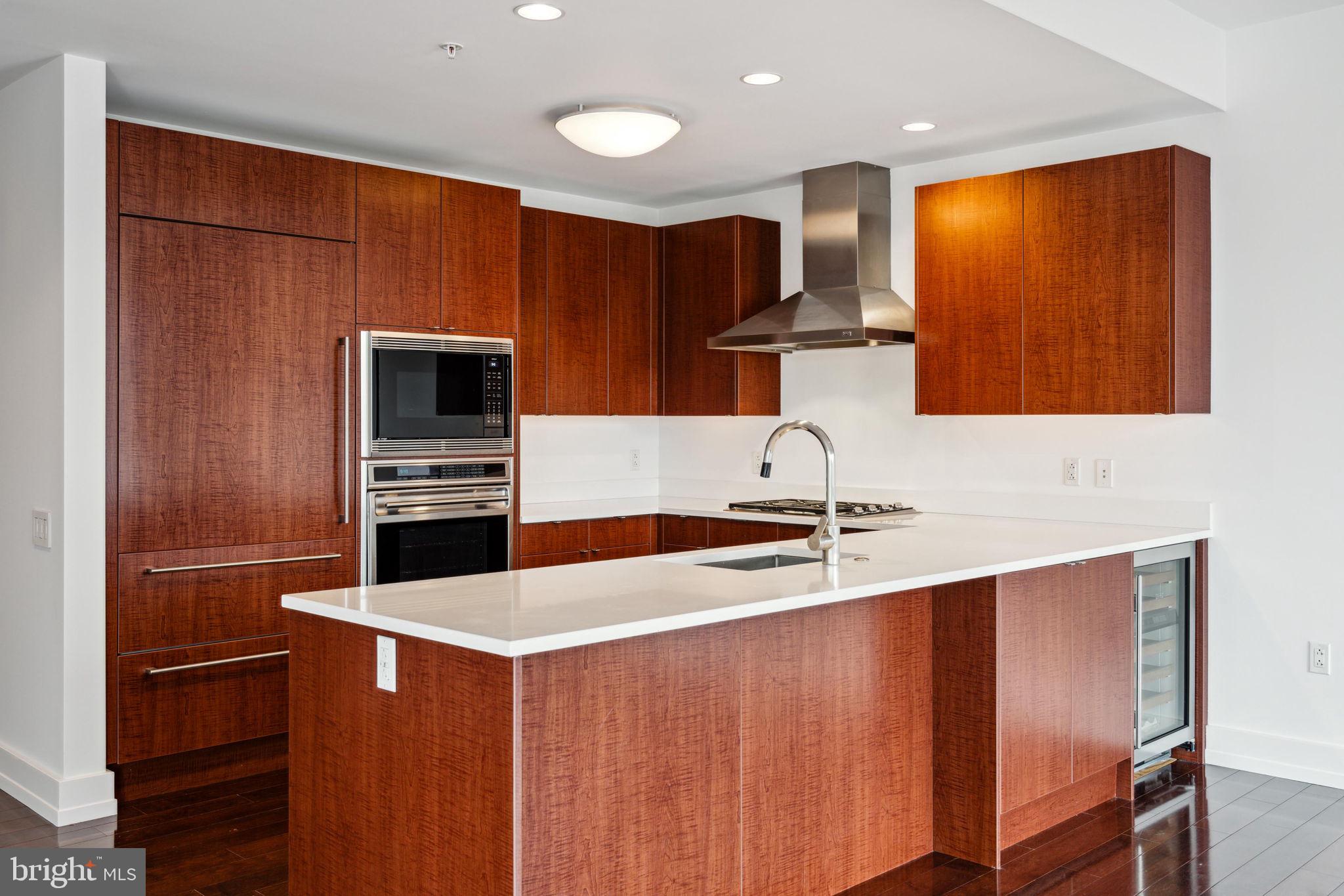 1706 Rittenhouse Square, Unit 402 Philadelphia, PA 19103 - Photo 5 of 27 a kitchen with stainless steel appliances granite countertop a sink stove and refrigerator