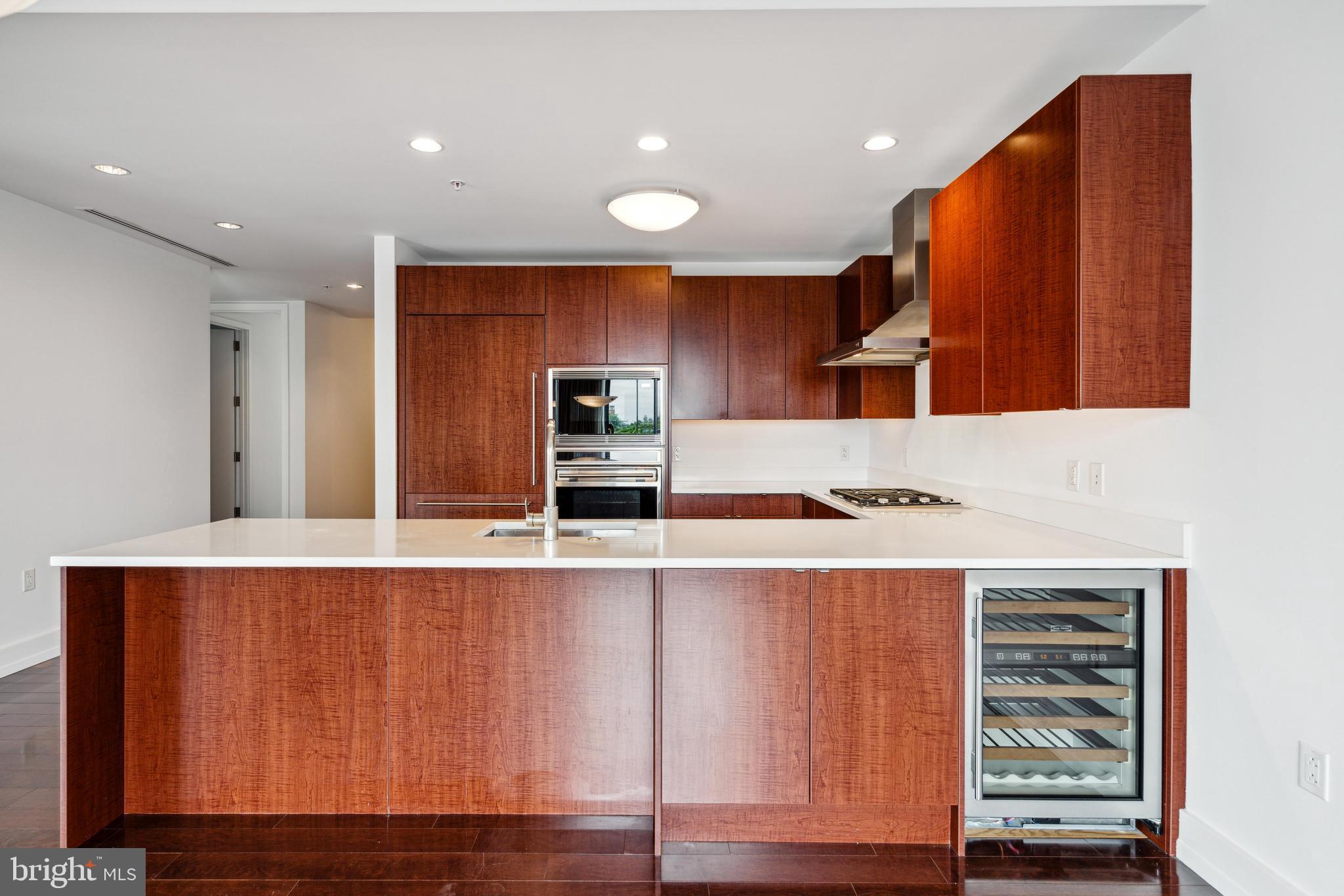 1706 Rittenhouse Square, Unit 402 Philadelphia, PA 19103 - Photo 7 of 27 a view of kitchen with stainless steel appliances wooden cabinets and a refrigerator