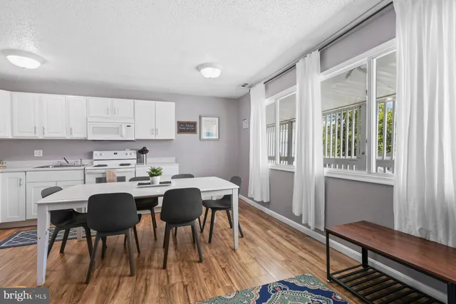 a view of a dining room with furniture and wooden floor
