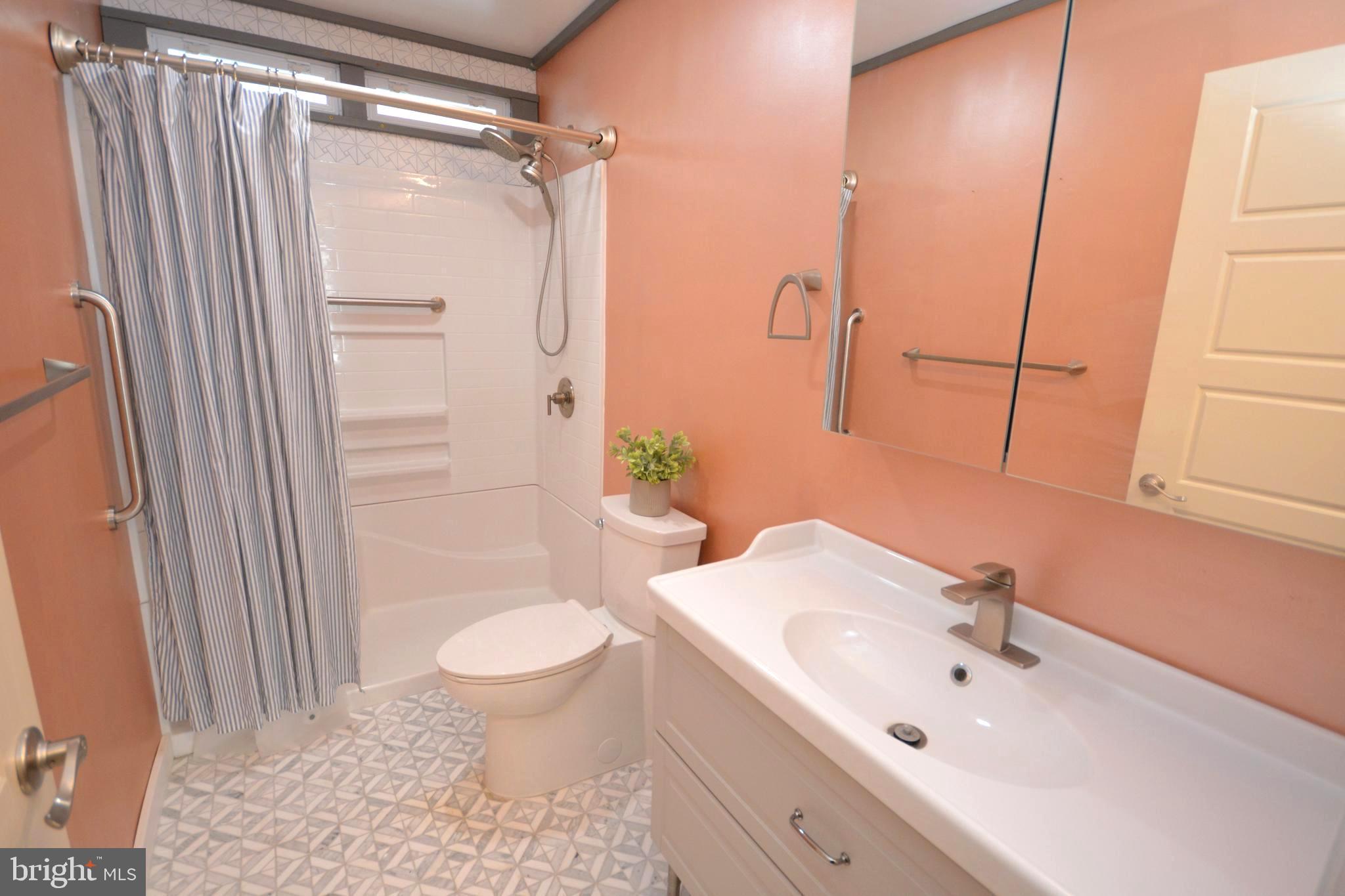 106 B Conner Street St. Michaels, MD 21663 - Photo 12 of 27 a bathroom with a sink toilet and shower